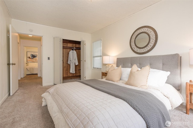 bedroom featuring a textured ceiling, a closet, and light colored carpet