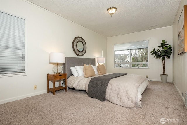 bedroom featuring baseboards, a textured ceiling, and light colored carpet