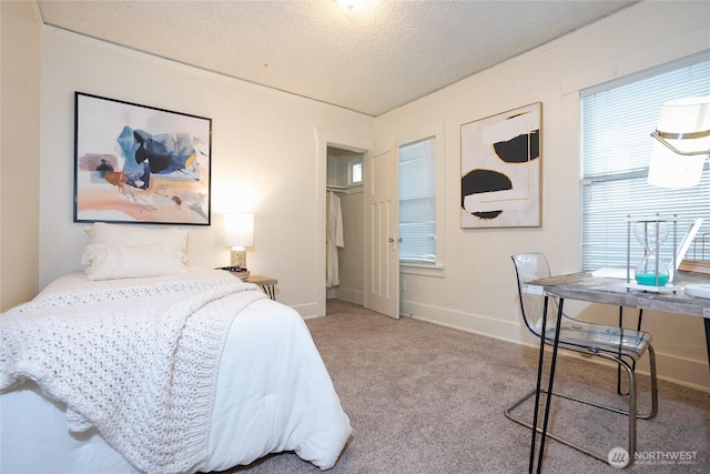 bedroom with a textured ceiling, baseboards, and light colored carpet