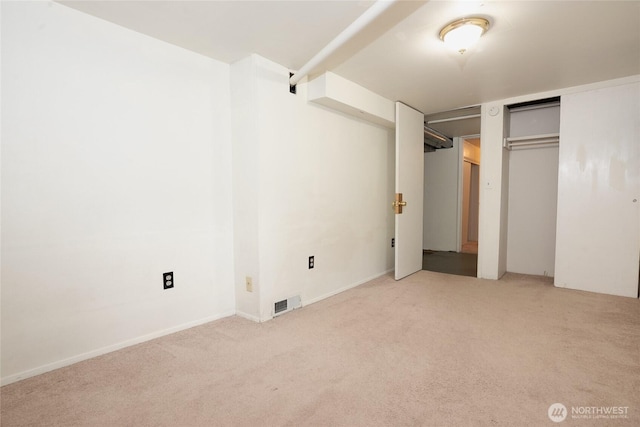 unfurnished bedroom with light colored carpet and visible vents