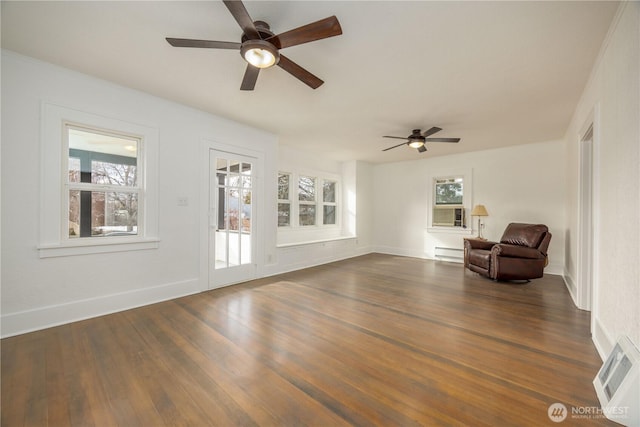 unfurnished room featuring a ceiling fan, baseboards, dark wood finished floors, and baseboard heating