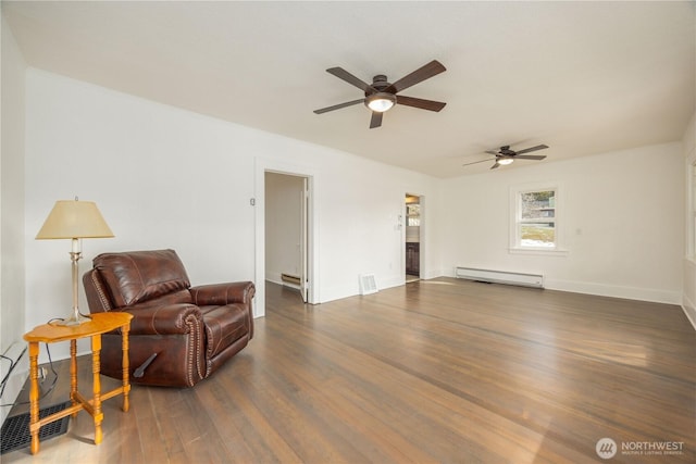 living area featuring a baseboard radiator, visible vents, a baseboard heating unit, and dark wood-style flooring