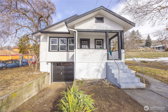 view of front of house with a garage and stucco siding