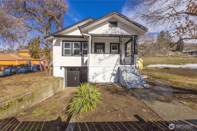 view of front of house featuring a garage and stucco siding