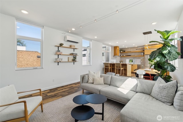 6610 Corson Ave S, Seattle, WA 98108 - living area featuring baseboards, a wall mounted air conditioner, recessed lighting, and wood finished floors