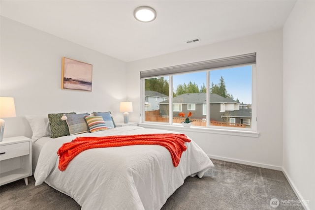 bedroom featuring baseboards, visible vents, and carpet flooring