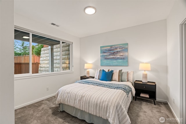 carpeted bedroom with visible vents and baseboards