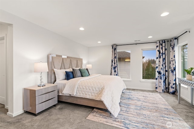 bedroom with recessed lighting, light colored carpet, and baseboards