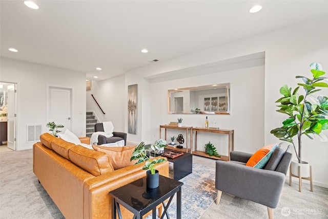 living room with recessed lighting, stairs, visible vents, and light colored carpet