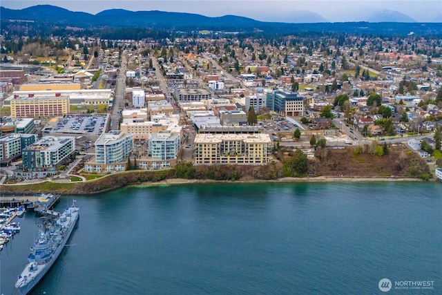 drone / aerial view with a city view and a water and mountain view