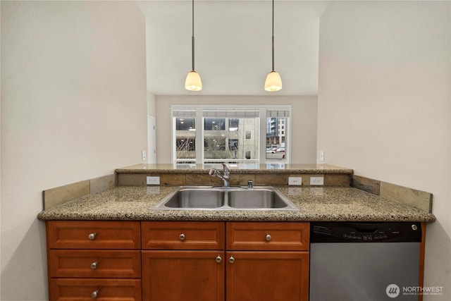 kitchen with brown cabinetry, light stone countertops, stainless steel dishwasher, pendant lighting, and a sink