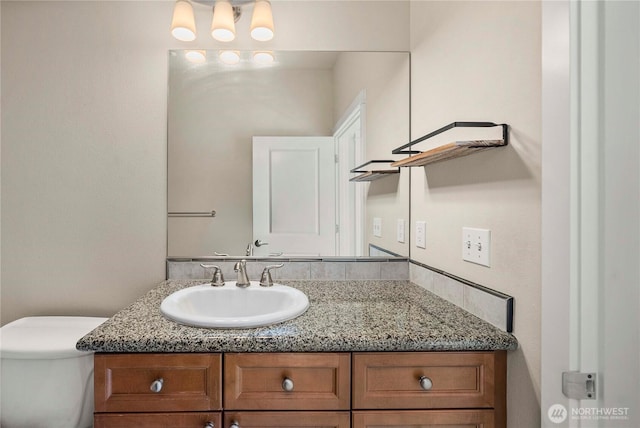 bathroom featuring toilet and vanity