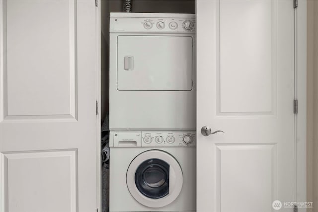 washroom with laundry area and stacked washer / drying machine