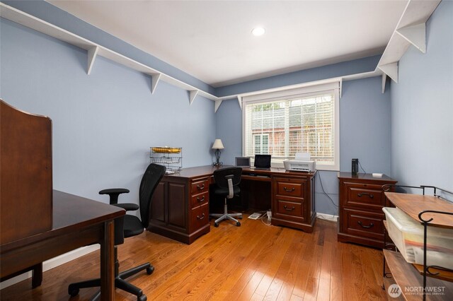 office with light wood-style floors and baseboards