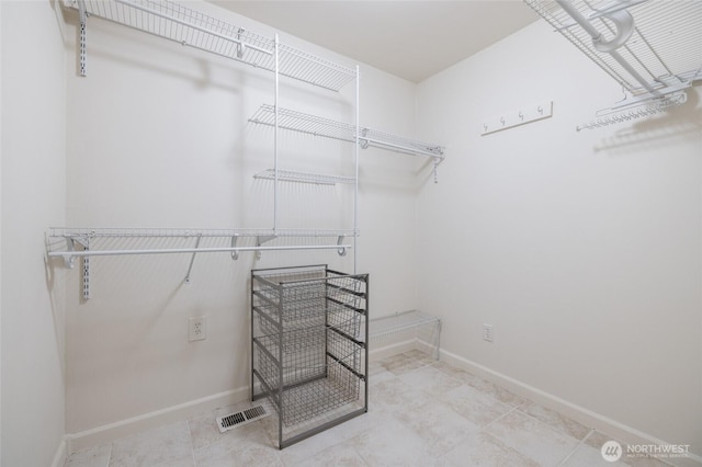 spacious closet featuring visible vents