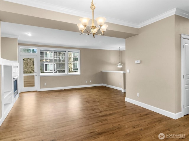 unfurnished living room featuring a glass covered fireplace, an inviting chandelier, wood finished floors, and crown molding