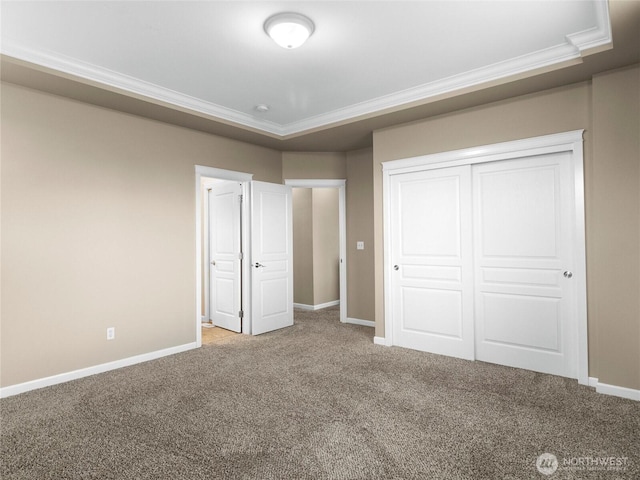 unfurnished bedroom with baseboards, ornamental molding, a closet, and light colored carpet