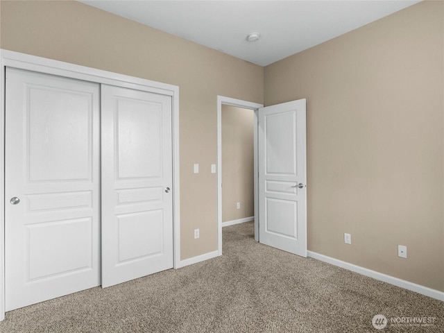 unfurnished bedroom featuring a closet, carpet flooring, and baseboards