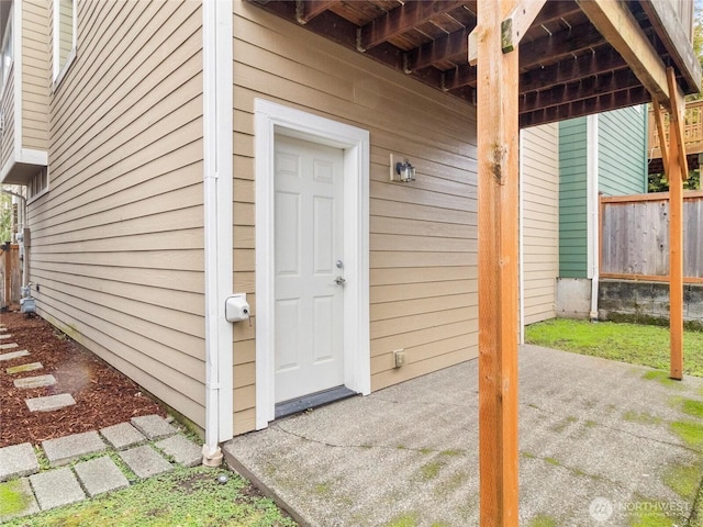 doorway to property with a patio area and fence