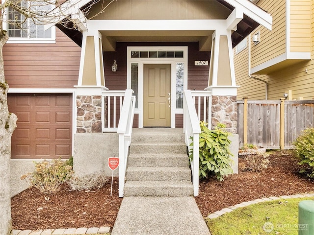 entrance to property featuring stone siding and fence