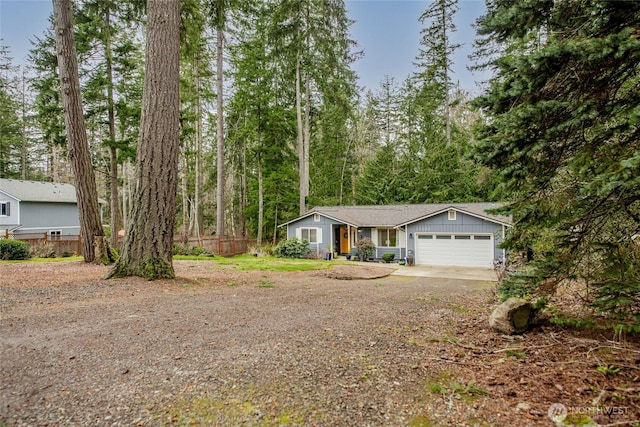 view of front of house with a garage, driveway, and fence