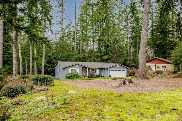 ranch-style house with a garage and dirt driveway