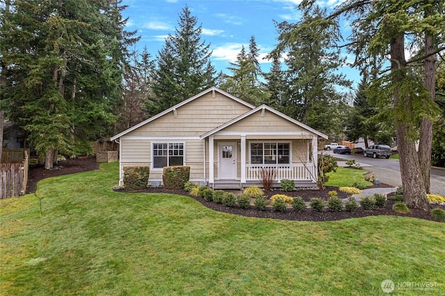 view of front of home featuring a front yard and covered porch