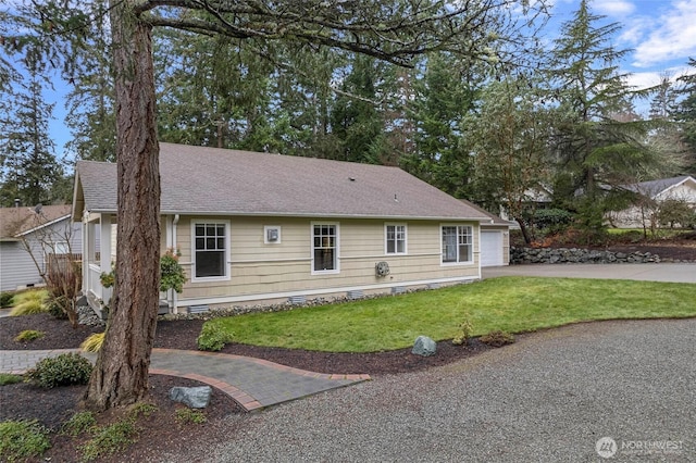 exterior space with a garage, crawl space, roof with shingles, and a lawn