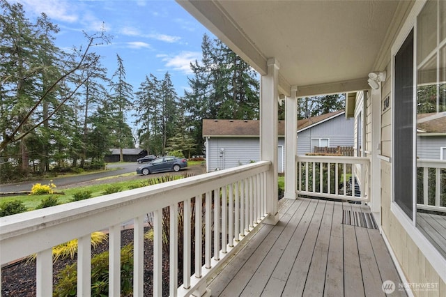 wooden terrace featuring covered porch