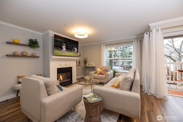 living room with a fireplace, baseboards, crown molding, and wood finished floors