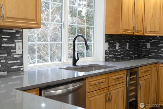 kitchen with stainless steel dishwasher, wine cooler, decorative backsplash, and a sink