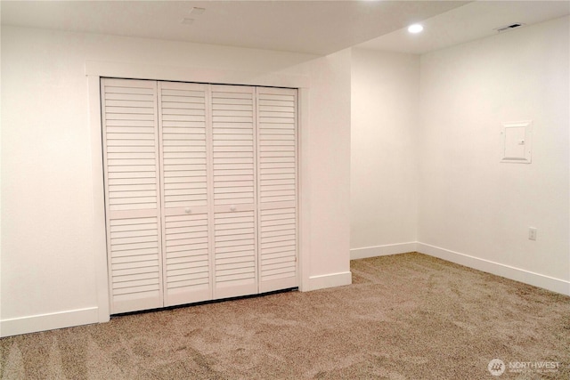 unfurnished bedroom featuring carpet floors, a closet, and baseboards