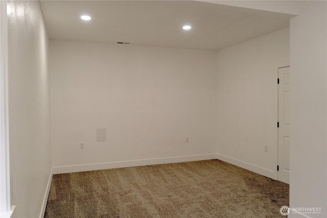 carpeted empty room featuring baseboards and recessed lighting