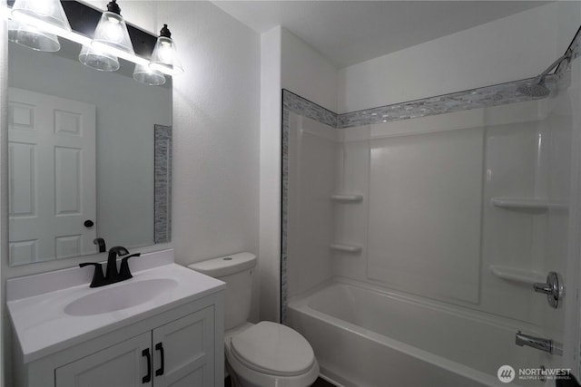 full bathroom with bathtub / shower combination, vanity, and toilet