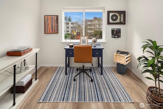 home office featuring baseboards and wood finished floors