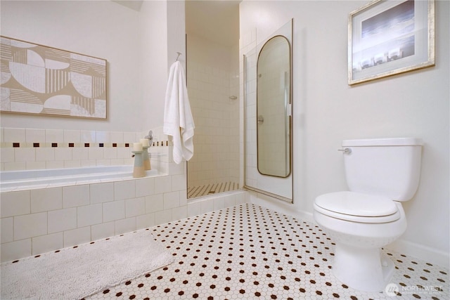 full bathroom with baseboards, toilet, tile patterned flooring, a tile shower, and a bath