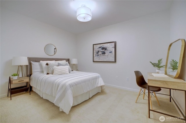 bedroom featuring light carpet and baseboards