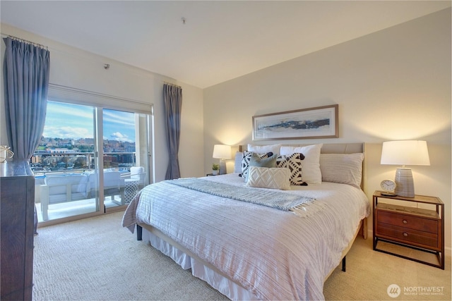 bedroom with access to outside and light colored carpet