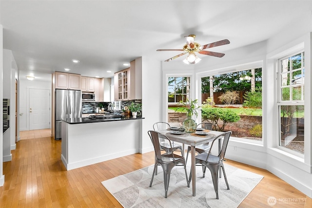 dining space featuring baseboards, recessed lighting, a ceiling fan, and light wood-style floors