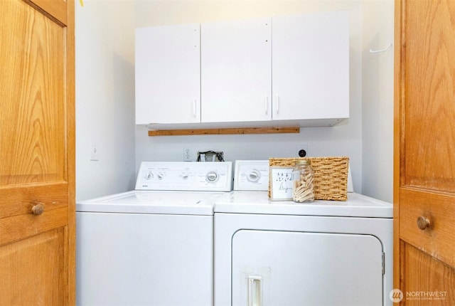 laundry room with cabinet space and separate washer and dryer