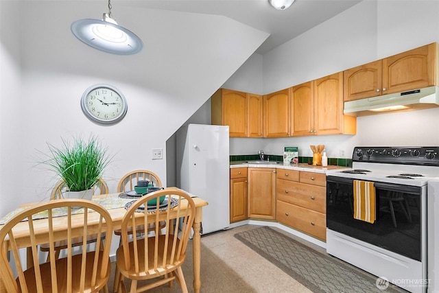 kitchen with light floors, freestanding refrigerator, a sink, electric range oven, and under cabinet range hood