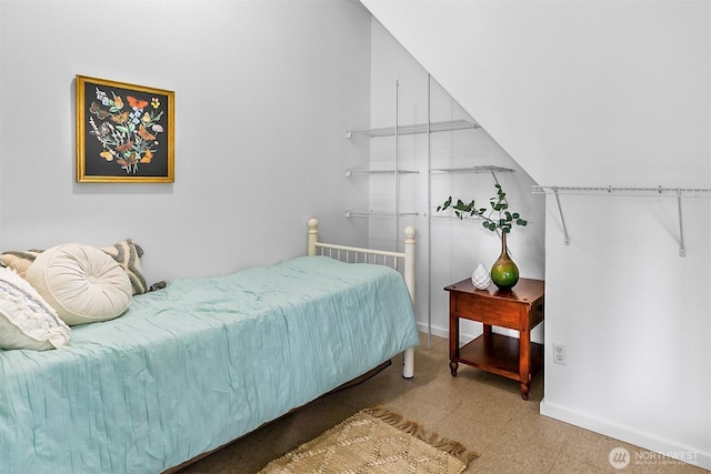 bedroom with tile patterned floors and baseboards