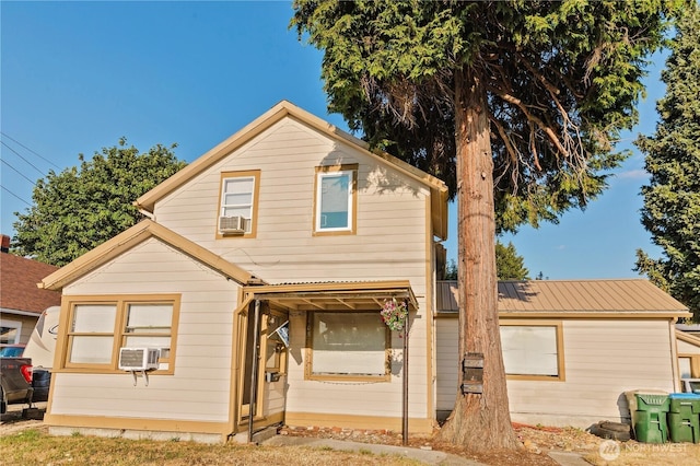 traditional-style home with cooling unit and metal roof