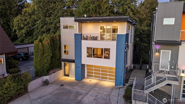 contemporary house featuring a balcony and stairway