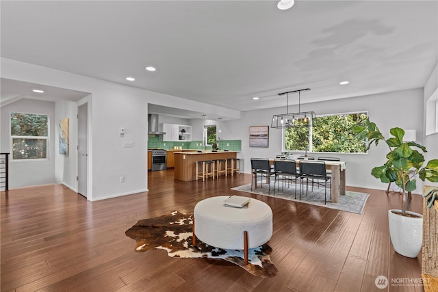 living area featuring dark wood-style floors, baseboards, and recessed lighting