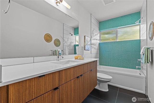 bathroom with bathing tub / shower combination, visible vents, toilet, vanity, and tile patterned floors