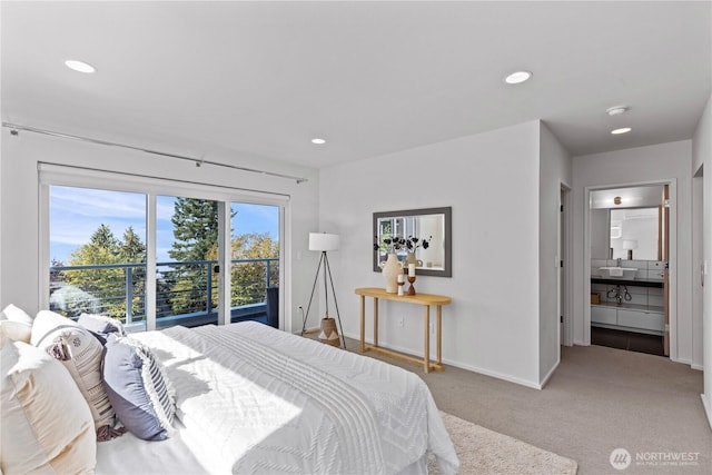 bedroom featuring recessed lighting, light colored carpet, baseboards, and ensuite bathroom