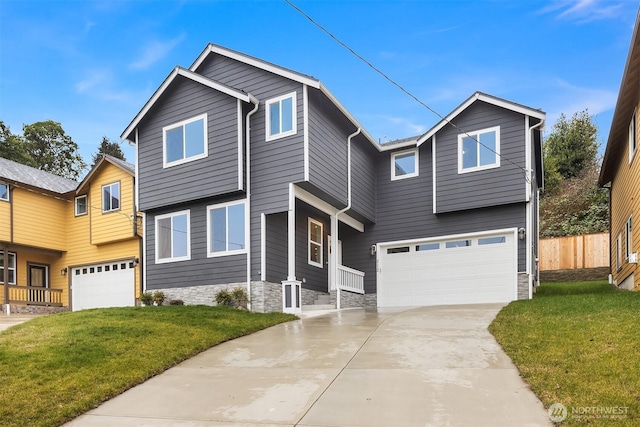 view of front of house featuring an attached garage, a front yard, fence, stone siding, and driveway