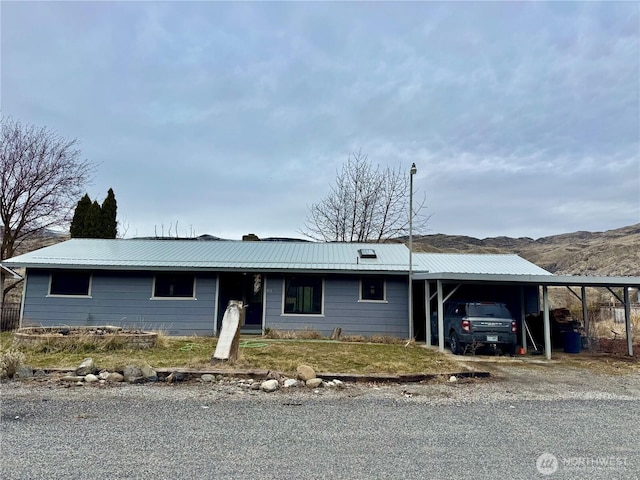 ranch-style house featuring a carport and metal roof