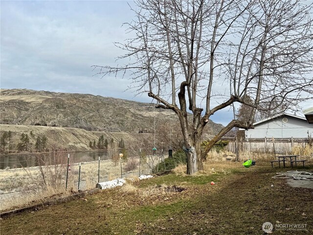 view of yard with a mountain view and fence